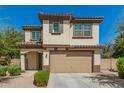 Charming two-story home featuring a desert landscape, shuttered window, and a two-car garage at 263 N Wilson Dr, Chandler, AZ 85225