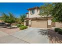 Two-story home with a two-car garage, desert landscaping and a paved driveway at 263 N Wilson Dr, Chandler, AZ 85225