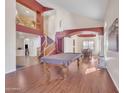 Open-concept living room showcasing high ceilings, a staircase, wood floors, and views into the dining room and second story at 2642 S Joplin --, Mesa, AZ 85209