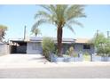 Street view of a single-story home with solar panels and a driveway leading to a carport at 2718 W Montebello Ave, Phoenix, AZ 85017