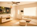 Bright living room with neutral tones, sectional sofa, and a modern entertainment center at 2718 W Montebello Ave, Phoenix, AZ 85017