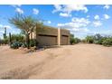 Large garage with two doors and desert landscaping at 27203 N 64Th Way, Scottsdale, AZ 85266