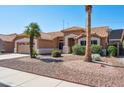 Inviting single-story home with desert landscaping, a spacious two-car garage and a tile roof at 3133 E Redwood Ct, Phoenix, AZ 85048