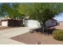 Single-story home features a spacious driveway, two-car garage, and desert landscaping at 3534 N 106Th Ln, Avondale, AZ 85392