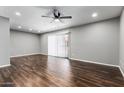 Bright living room with wood flooring, neutral walls, and sliding doors for natural light at 3810 N Maryvale Pkwy # 2020, Phoenix, AZ 85031