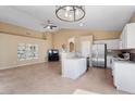 Open concept kitchen with white cabinets, stainless steel appliances, and island overlooking the living area at 4459 E Desert Wind Dr, Phoenix, AZ 85044