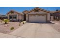 View of home highlighting garage, desert landscaping and front yard at 509 W Villa Rita Dr, Phoenix, AZ 85023