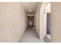 Inviting entryway showcasing a decorative front door, textured walls, and a glimpse of the interior at 654 E Buckingham Ave, Gilbert, AZ 85297