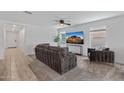 Comfortable living room with neutral tones, carpeted floors, a ceiling fan, and ample natural light at 654 E Buckingham Ave, Gilbert, AZ 85297