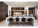 Modern kitchen with sleek cabinetry, a center island, and state-of-the-art appliances at 6702 E Cholla St, Scottsdale, AZ 85254