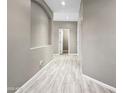 Inviting hallway with modern tile flooring, neutral paint, and recessed lighting showcases the home's layout at 6712 W Northview Ave, Glendale, AZ 85303