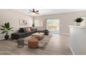 Cozy living room featuring tile floors, a comfortable sectional sofa, and sliding glass doors to the patio at 6712 W Northview Ave, Glendale, AZ 85303