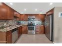 Modern kitchen with stainless steel appliances, updated countertops, and dark wood cabinetry at 7960 E Camelback Rd # 409, Scottsdale, AZ 85251