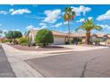 Attractive home on corner lot with desert landscaping featuring a two-car garage and beautiful mature shade trees at 8958 W Rosemonte Dr, Peoria, AZ 85382