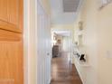 Inviting hallway showcasing neutral wall paint, a closet, and decorative wall shelving at 8958 W Rosemonte Dr, Peoria, AZ 85382