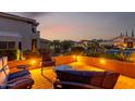 Inviting outdoor patio with comfortable seating around a cozy fire pit, perfect for relaxing and enjoying the evening at 9569 W Redbird Rd, Peoria, AZ 85383