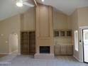 Bright and airy living room with a fireplace, built-in shelves, and a wet bar at 10190 N 106Th E St, Scottsdale, AZ 85258