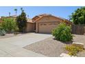 Charming single-story home with a desert-style front yard and a two-car garage at 10367 E Wood Dr, Scottsdale, AZ 85260