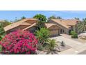 Beautiful single-story home with a well-kept desert front yard and attached garage at 10367 E Wood Dr, Scottsdale, AZ 85260