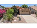 Inviting single-story home featuring a well-manicured desert front yard and two-car garage at 10367 E Wood Dr, Scottsdale, AZ 85260