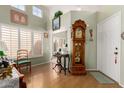 Inviting entryway with high ceilings, wood floors, and a charming grandfather clock at 14428 W Moccasin Trl, Surprise, AZ 85374