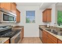 Efficient kitchen featuring stainless steel appliances, a double sink, and tile flooring at 14815 N Fountain Hills Blvd # 201, Fountain Hills, AZ 85268