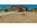 Charming single-Gathering home featuring desert landscaping, inviting entrance and well-maintained exterior at 15354 W Caribbean Ln, Surprise, AZ 85379