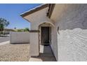Exterior front door and walkway of a single Gathering home with desert landscaping at 16523 W Desert Bloom St, Goodyear, AZ 85338