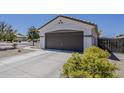 Single Gathering house with a two car garage, concrete driveway and desert landscaping at 16523 W Desert Bloom St, Goodyear, AZ 85338