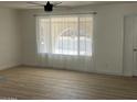 Cozy living room featuring new flooring and a large window providing ample natural light at 18045 N 20Th N Ln, Phoenix, AZ 85023