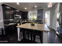 Stylish kitchen with dark wood cabinets, an island with seating, and stainless steel appliances at 1812 S Racine Ln, Gilbert, AZ 85295