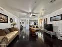 Spacious living room with gleaming hardwood floors, neutral walls and a ceiling fan at 1812 S Racine Ln, Gilbert, AZ 85295