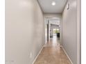 Bright hallway features tile floors and neutral walls, leading to the living area and backyard at 2053 E Saddlebrook Ct, Gilbert, AZ 85298