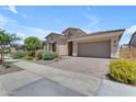 Attractive single-story home with a tiled roof, paver driveway, and well-maintained desert landscaping at 22788 E Orion Way, Queen Creek, AZ 85142