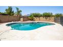 Backyard pool surrounded by a tiled patio and block fence, offering a private outdoor oasis at 2338 E Javelina Ave, Mesa, AZ 85204