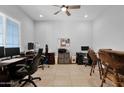 Spacious home office featuring a ceiling fan and multiple workstations at 27667 W Mohawk Ln, Buckeye, AZ 85396