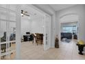 Spacious office with bar, French doors, and views of the living area at 27667 W Mohawk Ln, Buckeye, AZ 85396