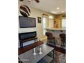 Well-appointed living room with breakfast bar, fireplace, and a flatscreen TV at 2929 E Main St # 601, Mesa, AZ 85213