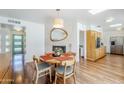 Inviting dining room featuring wood floors, a stone fireplace and modern lighting at 314 E Royal Palm Rd, Phoenix, AZ 85020
