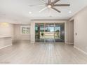 Bright living room features sliding glass doors to the backyard and neutral-toned walls and flooring at 3948 E Caitlin Dr, San Tan Valley, AZ 85140