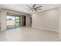 This living room features sliding glass doors that lead to the backyard and tile floors at 3948 E Caitlin Dr, San Tan Valley, AZ 85140