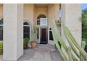 Inviting front entrance with flagstone walkway, arched windows, and lush desert landscaping at 4146 N Lomond --, Mesa, AZ 85215