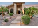 The desert-landscaped front yard has stone steps leading to the inviting covered porch of this home at 4146 N Lomond --, Mesa, AZ 85215