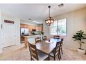 Comfortable dining room featuring a wooden table, pendant lighting, and adjacent kitchen space, ideal for Gathering meals at 4379 E Rosemonte Dr, Phoenix, AZ 85050