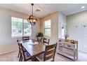 Inviting dining area filled with natural light, wood furniture, and neutral decor offering a warm and welcoming atmosphere at 4379 E Rosemonte Dr, Phoenix, AZ 85050