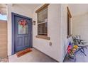 Inviting front porch with decorative door and a cozy seating area, perfect for enjoying the outdoors and neighborhood views at 4379 E Rosemonte Dr, Phoenix, AZ 85050