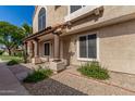 Two-story home featuring stucco exterior, decorative columns, and well-kept desert landscaping at 4601 N 102Nd Ave # 1178, Phoenix, AZ 85037