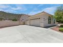 Spacious three-car garage with an extra-wide driveway, perfect for ample parking and storage at 5949 W Pinnacle Hill Dr, Glendale, AZ 85310