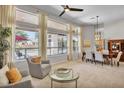 Cozy living room with plush seating, large windows offering backyard pool views, and modern decor at 6135 E Campo Bello Dr, Scottsdale, AZ 85254