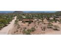 Expansive aerial view of desert property, showcasing a home with surrounding native vegetation and mountain views at 6608 E Ranch Rd, Cave Creek, AZ 85331